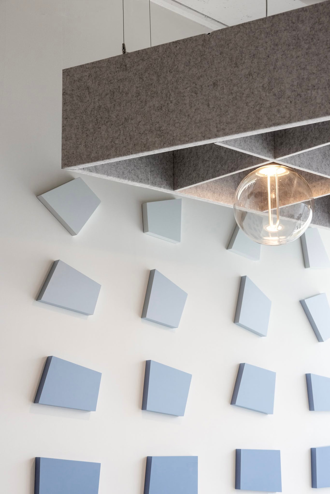 Close up — each panel is angled and shadowed so the gradient shifts as you walk past.