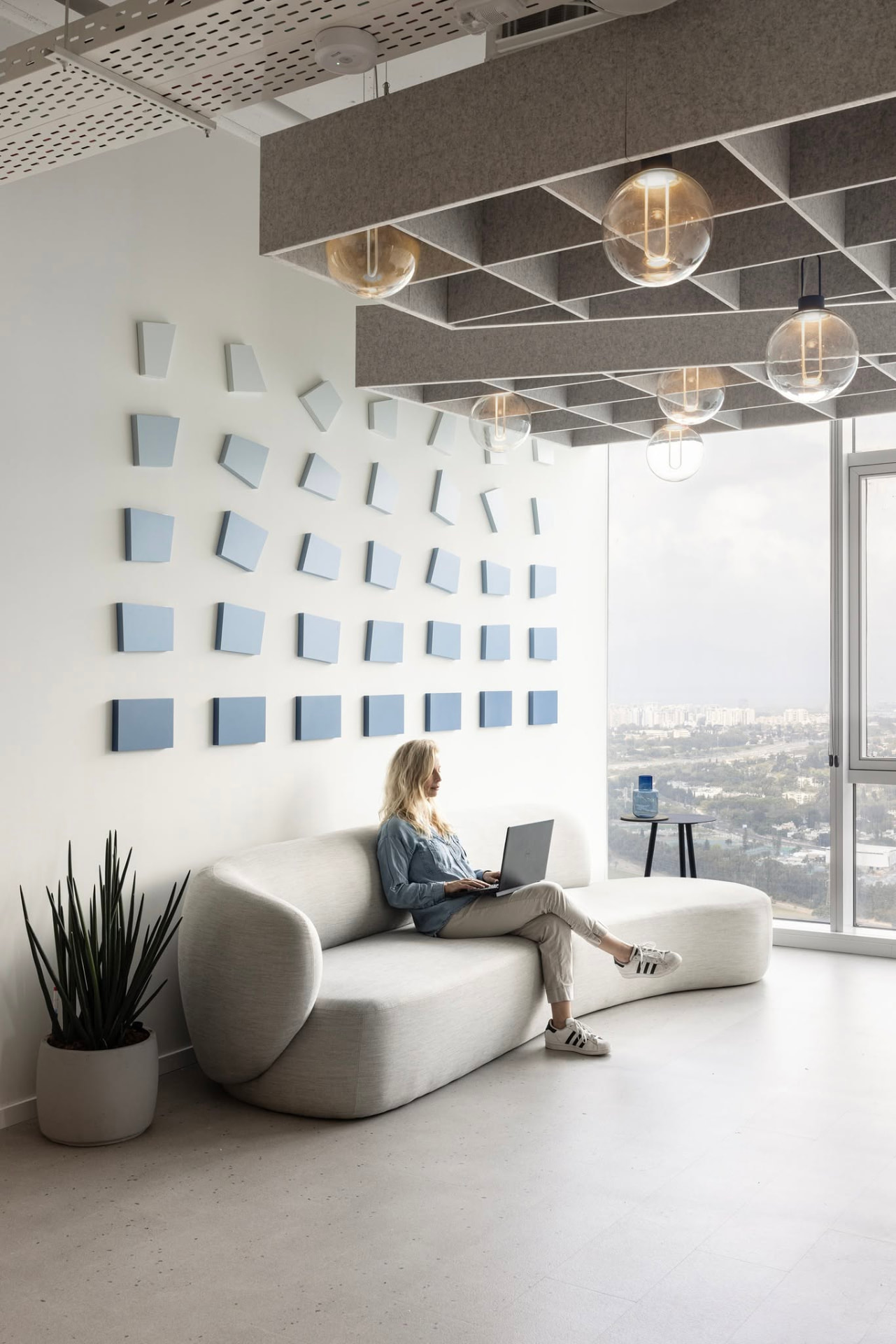 In use — the piece sits low enough to frame the lounge without crowding it.