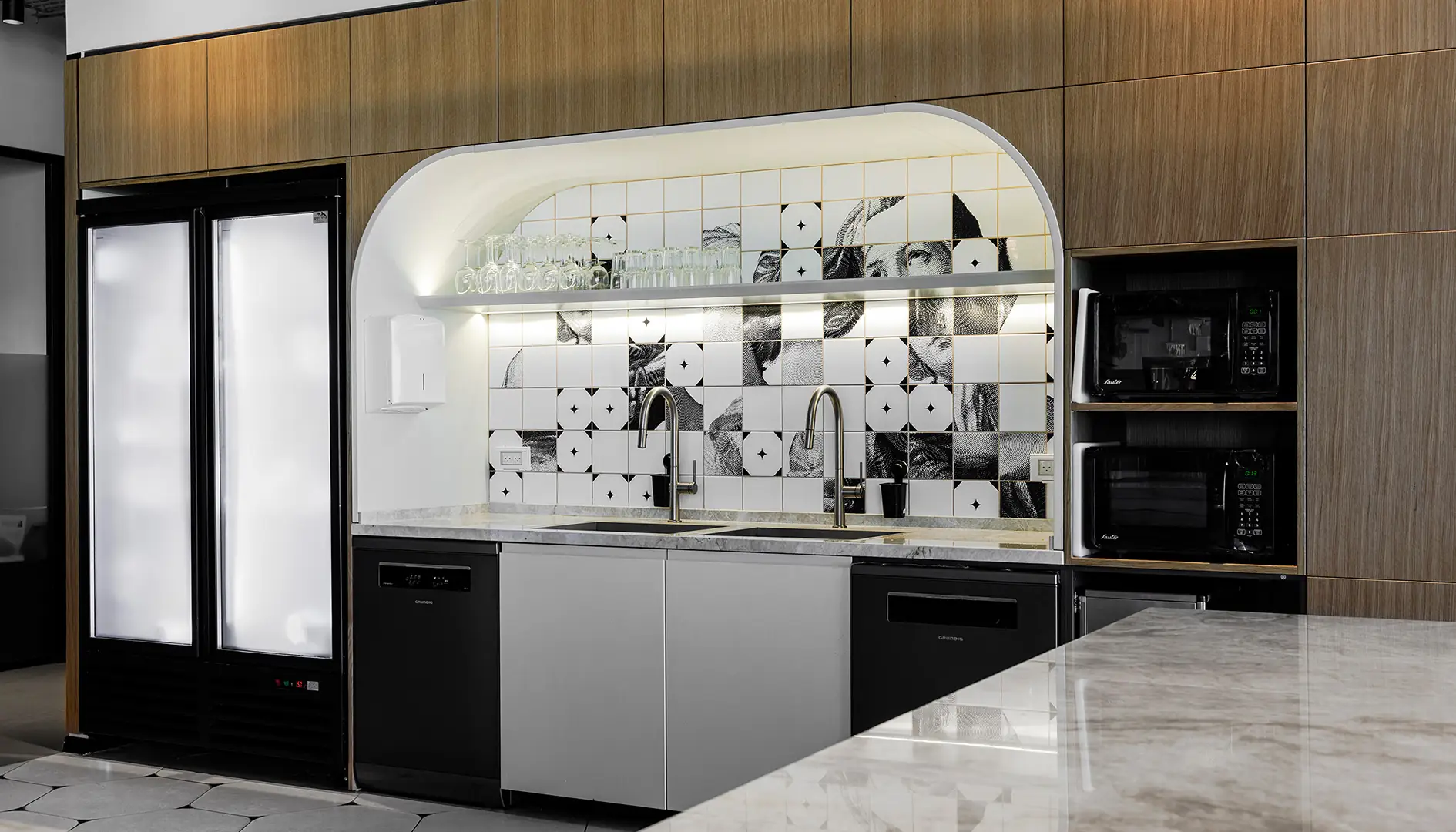 Tile wall — black and white engravings fragmented across the grid under the arch.