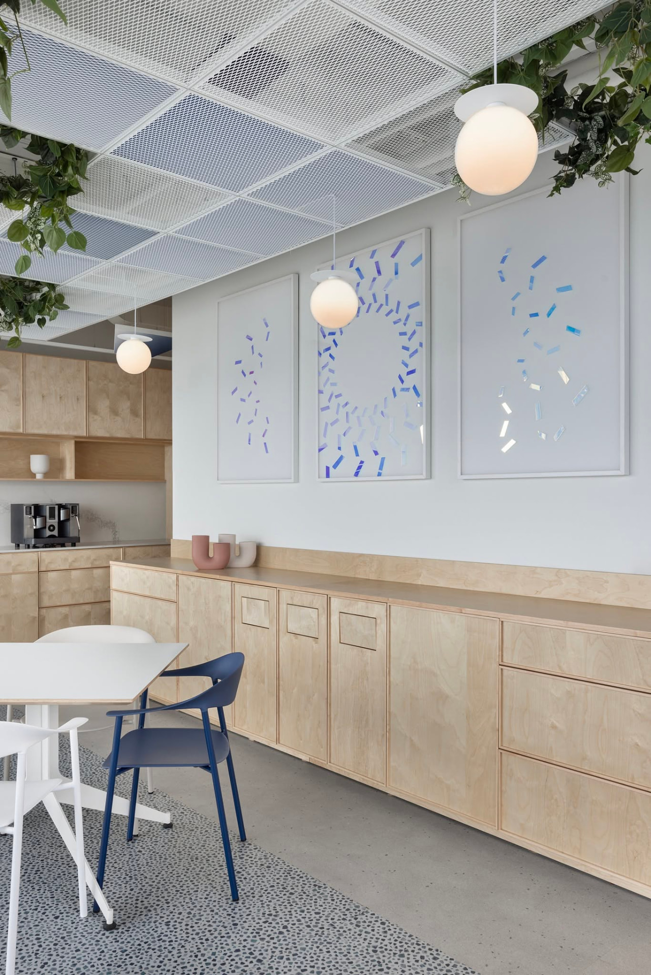 Kitchen frames — blue fragments scattered, orbiting and settling across three panels.